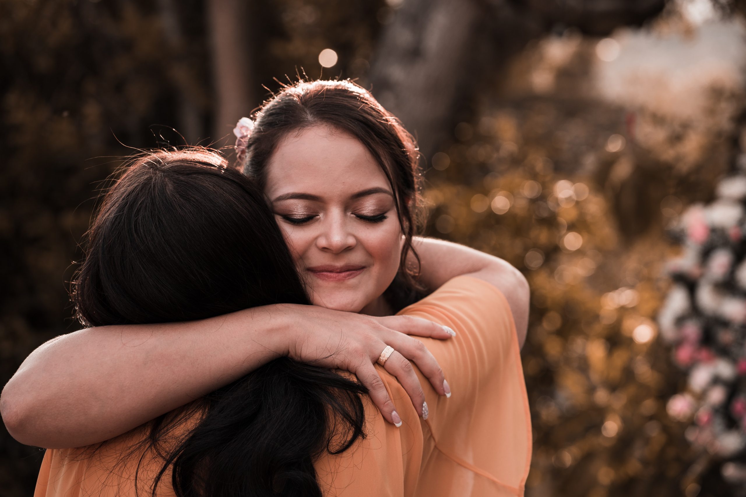 Two females hugging and supporting each other, practicing mindfulness