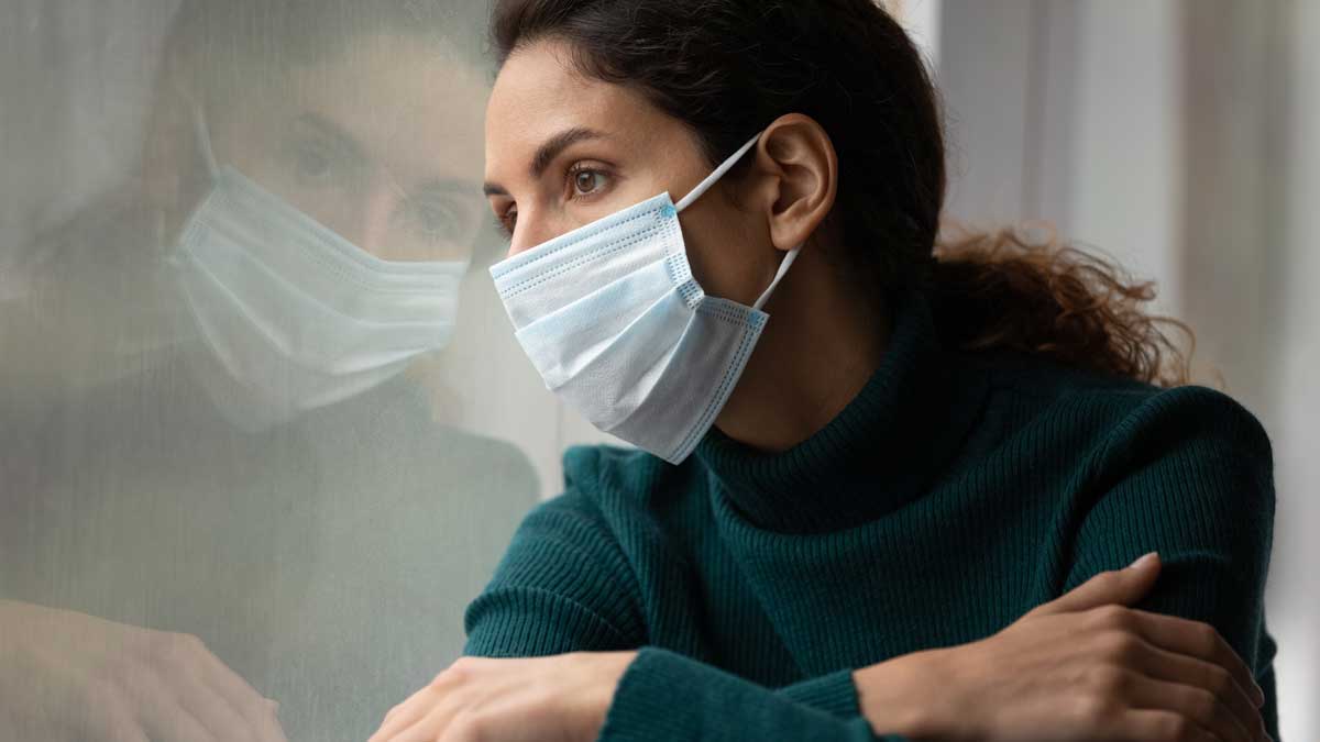 Unhappy female in facemask suffer from coronavirus. Quarantine, corona pandemic concept.