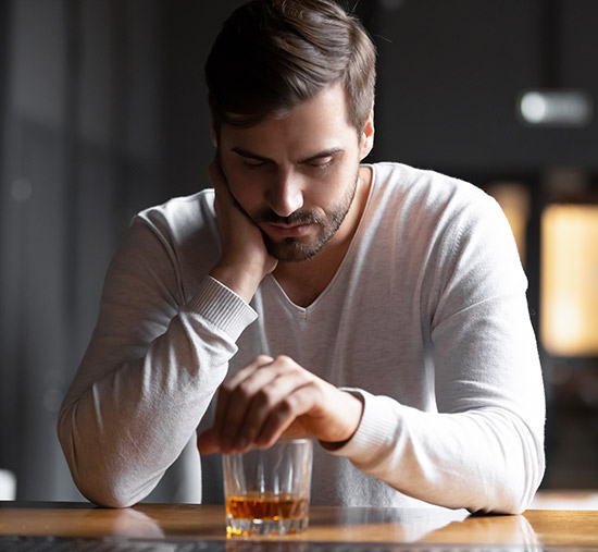 Person struggling with alcohol addiction | Featured Image for Alcohol Rehab Melbourne Service Page on Hills & Ranges Melbourne.